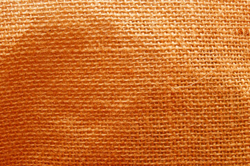 Fototapeta premium The texture is orange-colored burlap. Coarse fabric.