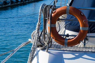 Lifebuoy or orange life ring on white ship with Black sea backdrop. Safety equipment. Obligatory...