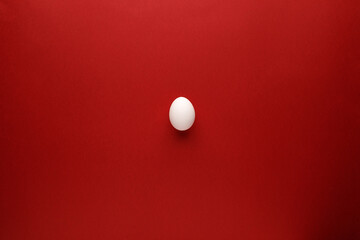 White easter egg with happy easter word, holiday concept. Red background. Top view