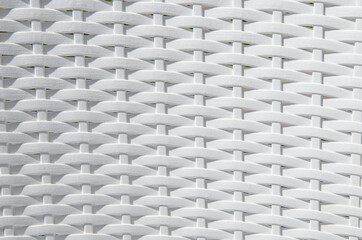 Texture of intertwined white plastic twigs. Backrest of a garden chair. Texture pattern for design, abstract background