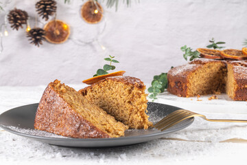 Christmas orange and spice cake. Decorated with dried oranges on kitchen countertop