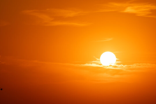 Golden hour sunset. View of sun. Details of sunset with orange sky.