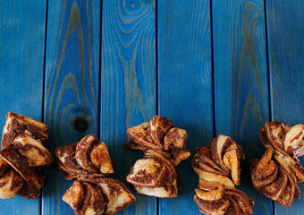 Fototapeta na wymiar Homemade cinnamon cookies on a blue wooden background. Space for text 