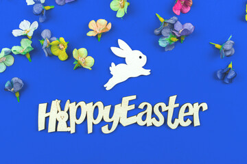 Happy Easter composition with text message and flat bunny decoration with spring flowers