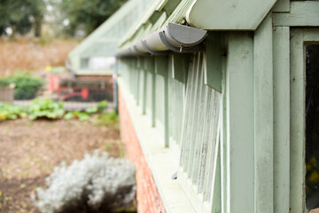 Potting shed or garden outhouse with vegetable patch to grow foodin the background