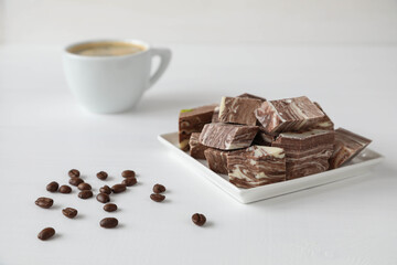Chocolate halva with a cup of coffee and coffee beans