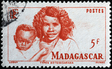 Mother with her son on vintage stamp from Madagascar