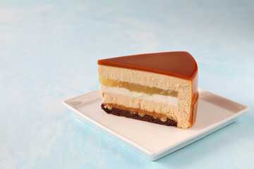 A single piece of mousse cake in a cut on a plate on the table