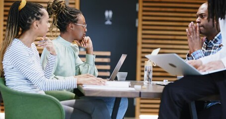Group of young businesspeople
discussing work in an office
 - Powered by Adobe