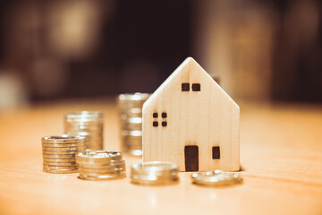 Wood house model and row of coin money on nature background, Real Estate market, Trading Estate, Mortgage Concepts