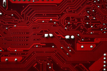 Red computer motherboard chip close-up with elements