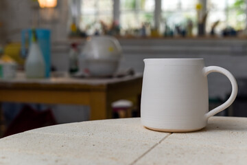 Collection of finished ceramics products made from clay by hand displayed on a kiln used in the firing process