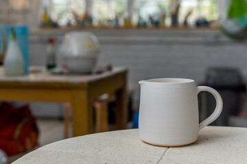 Collection of finished ceramics products made from clay by hand displayed on a kiln used in the firing process