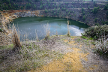 Lake in abandoned open pit mine of North Mathiatis, Cyprus. This area is rich with copper and sulphide deposits