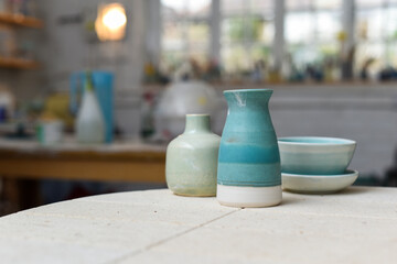 Collection of finished ceramics products made from clay by hand displayed on a kiln used in the...