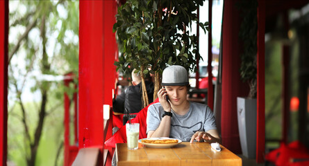 Lifestyle portrait of a young man using a smart phone outdoors