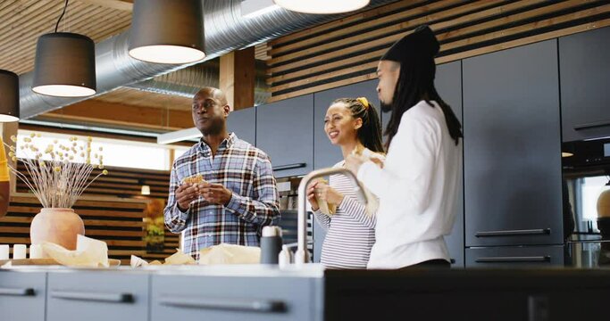 Young businesspeople laughing
during their office lunch break
