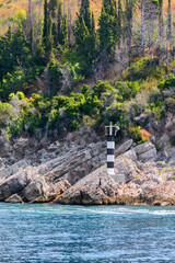 Boko-Kotorsky Bay. The coast of the Boko-Kotor Bay. Lighthouse on the shore. Montenegro