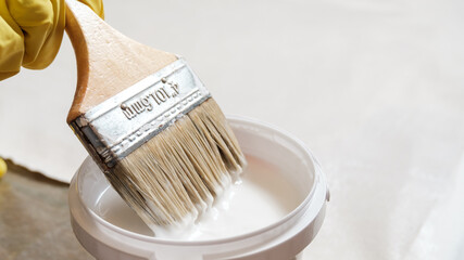 Applying white glue to cotton fabric with a brush