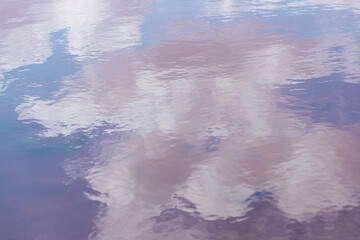 Background of clouds reflected in the sea. Delicacy and softness.