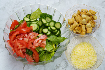 salad with vegetables and croutons and cheese on white background close up 