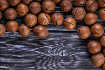 Fototapeta premium Macadamia nuts are cracked and baked to taste extremely delicious. Toasted organic healthy food.