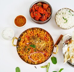 Indian Non veg meal Chicken biryani Roti Chilli chicken rice salan and Raita isolated on white