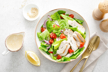 Salad with romaine lettuce, grilled chicken meat and tomatoes