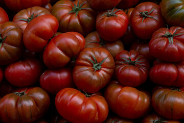 A lot of colorful and healthy tomatoes in a street market