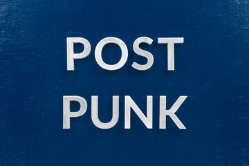 words post punk laid with aluminium letters over blue painted board surface