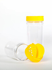 Cans for storing bulk products with yellow lids on white isolated background. Transparent plastic container with lid for storing food and bulk product. An empty jar for food. Copy space