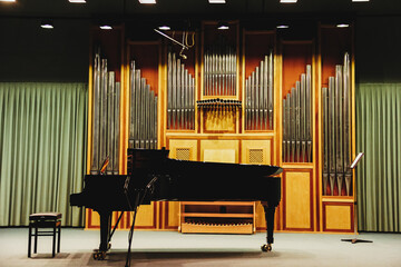 Grand piano on an empty stage in a concert hall