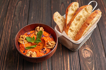 Muhammara, Eastern snack on a dark wooden board