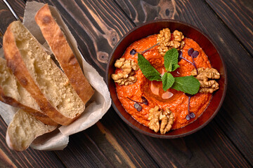 Muhammara, Eastern snack on a dark wooden board