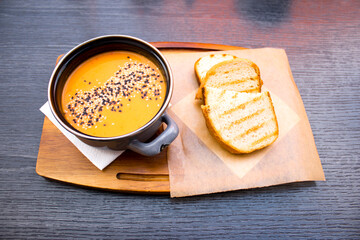 Above view of pumpkin soup with fried bread 