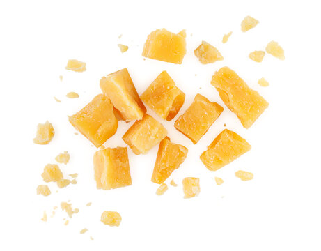 Heap of hard cheese parmesan isolated on a white background. Close up. Top view.