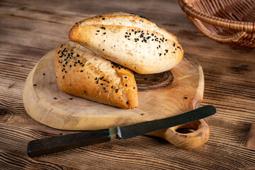 Fresh bread rolls on a rustic wooden table.