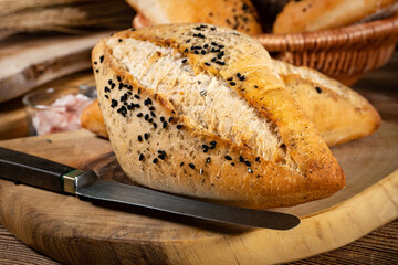 Fresh bread rolls on a rustic wooden table.