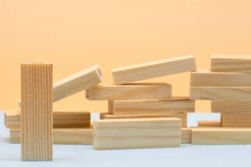 Fallen wooden blocks and one block standing. The concept of business leadership. Leadership
