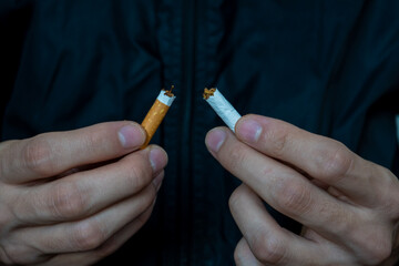 Young man breake down cigarette. Winning with addicted nicotine problems, stop smoking . Quitting from addiction concept.