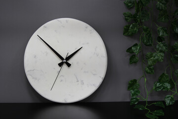 Decorative white marble wall clock, Modern analog wall clock and black watch dial.