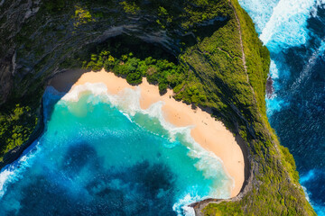Aerial view at sea and rocks. Natural landscape. Kelingking beach. Nusa Penida. Bali. Indonesia. Blue water background from top view. Travel and vacation image.