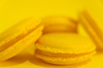 Yellow macaroons on yellow background