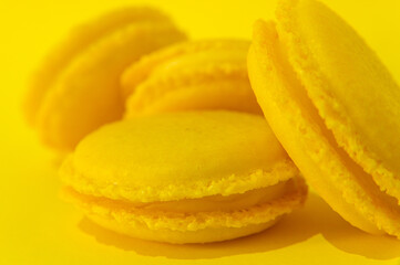 Yellow macaroons on yellow background