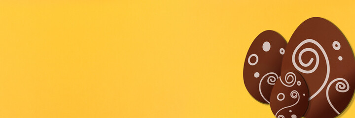Painted easter eggs on yellow background. Colorful. Paper texture. Illustration. Banner.