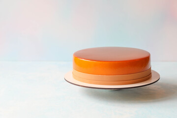 Single mousse cake on a stand on a table with copy space