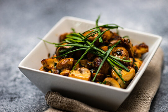 Traditional Georgian roasted Agaricus bisporus mushrooms with fresh chives