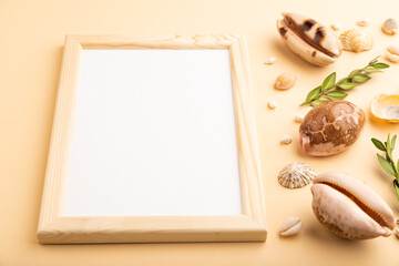 Composition with wooden frame, seashells, green boxwood. mockup on orange background. side view, copy space.