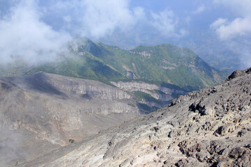 VIew from top of Mount Merapi is a bit foggy with hardened lava rock as the foreground.