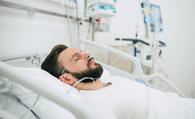 Infected patient with coronavirus in quarantine ward is lying in bed in the hospital.